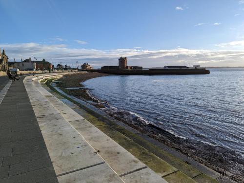 a sidewalk next to a body of water at Great Location, large 1 bed flat with parking in Broughty Ferry