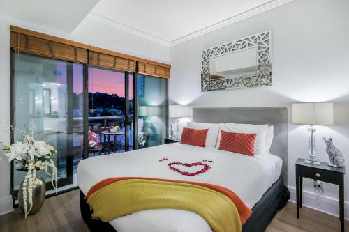 a bedroom with a bed with a heart on it at Your Next Viaduct Getaway! in Auckland