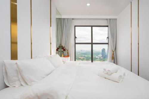 a white bed with white sheets and a window at 2Br-Top Fl-Amazing View-Hana Apt in Ho Chi Minh City