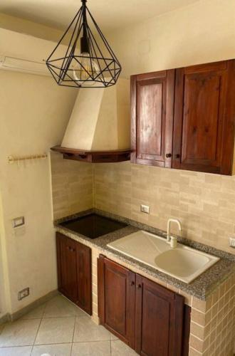 a kitchen with a sink and a stove top at Lo scrigno dei nonni in Ovada
