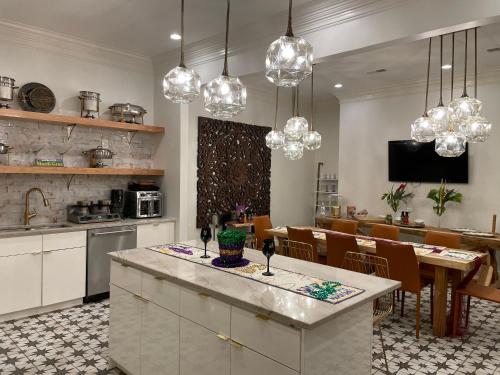 a kitchen and dining room with chandeliers at Serenity in the Marigny in New Orleans