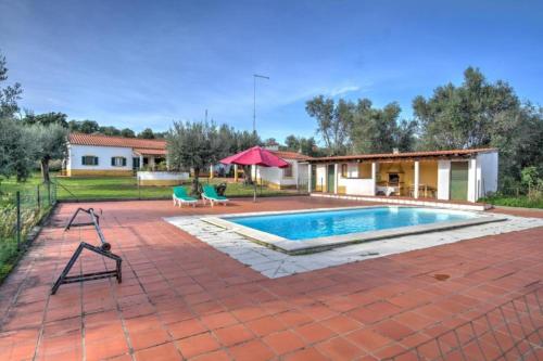 a swimming pool in a yard with a house at Country villa on Montargil in Montargil