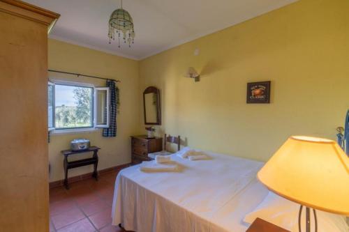 a bedroom with a bed and a window and a table at Country villa on Montargil in Montargil