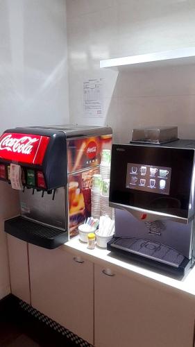 a counter with a coffee machine and a laptop on it at King Motel王者 in Taoyuan