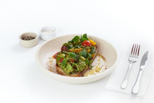 a white bowl of food on a table at The Lodge, Blacktown - Sydney in Rooty Hill