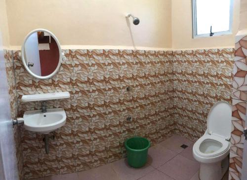 een badkamer met een wastafel, een toilet en een spiegel bij Azzura Budget Rooms in Zamboanga