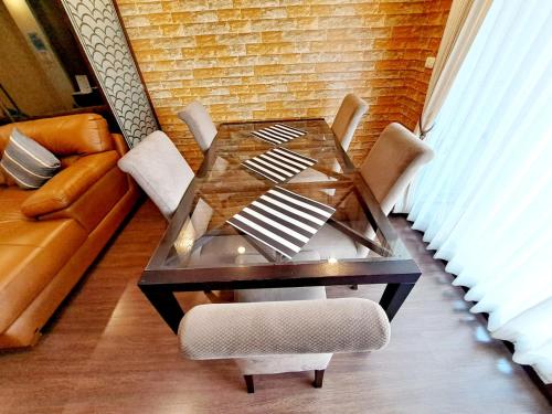 a glass table in a living room with a couch at 6C-Short-term rental allowed-2BRs Downtown Bangkok in Makkasan