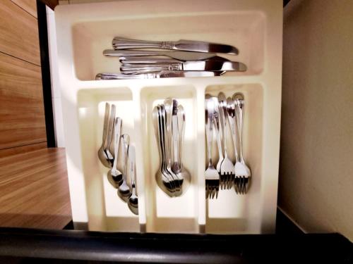 a group of forks and spoons in a plastic container at 6C-Short-term rental allowed-2BRs Downtown Bangkok in Makkasan