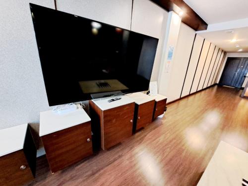 a living room with a large flat screen tv at 6C-Short-term rental allowed-2BRs Downtown Bangkok in Makkasan