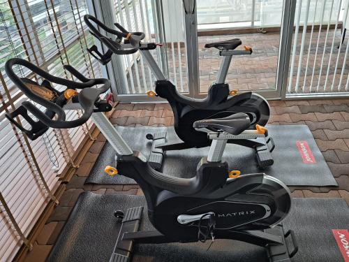 a row of exercise bikes in a gym at 6C-Short-term rental allowed-2BRs Downtown Bangkok in Makkasan