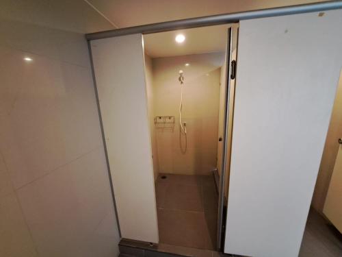 a shower with a glass door in a bathroom at 6C-Short-term rental allowed-2BRs Downtown Bangkok in Makkasan