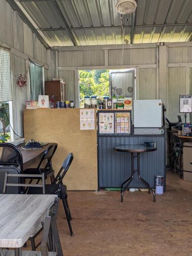 a room with tables and a counter in a building at ที่ราบสูง & โฮมสเตย์ in Ban Mae Na Tai