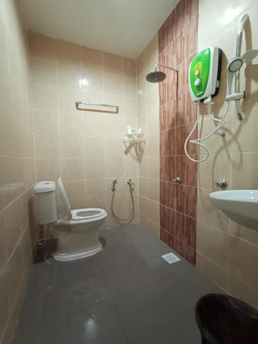 a bathroom with a toilet and a sink at Dane & Shue Hotel Kok Lanas in Kota Bharu
