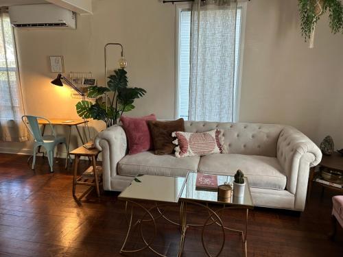 a living room with a couch and a table at Classic & Cozy Apartments - Parking & Close To Dw in Medford