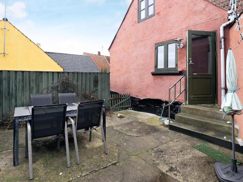 a table and chairs in front of a house at 4 person holiday home in Marstal-By Traum in Marstal