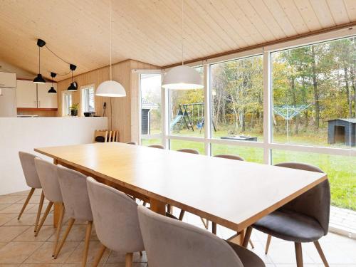 a kitchen and dining room with a large wooden table and chairs at 10 person holiday home in Fjerritslev-By Traum in Fjerritslev