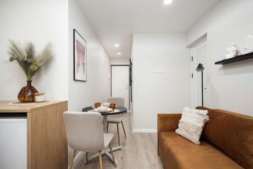 a living room with a couch and a table at Tyzenhauzu Apartment in Vilnius