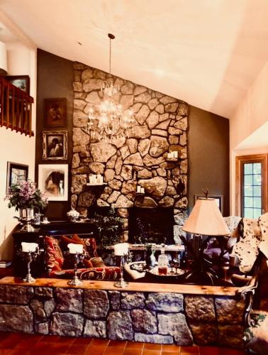 a living room with a large stone wall at Trail Boss King EnSuite-Prairie Rose B&B - 1200 sq ft Suite in Cheyenne