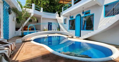 a swimming pool in front of a house at Rumah Batu in Buleleng