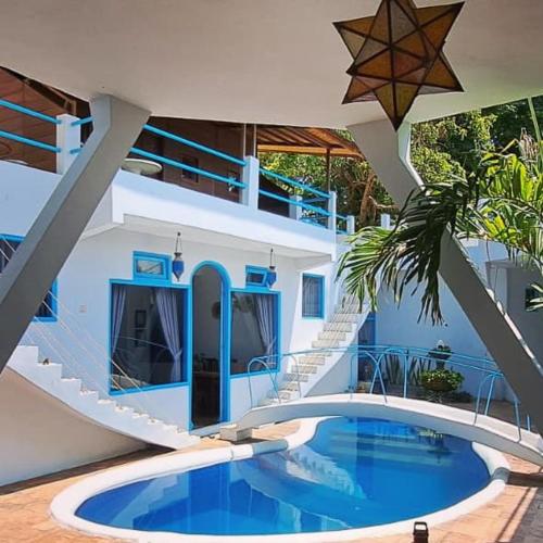 a house with a swimming pool and a staircase at Rumah Batu in Buleleng