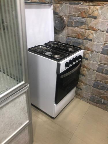 a white stove in a kitchen next to a wall at شقة in Alexandria