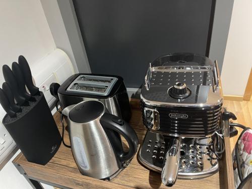 a kitchen counter with a coffee maker and a blender at Chic Citispace -1-Bed Apartment Leeds City-WiFi in Leeds