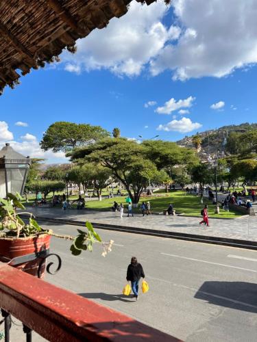 a man walking down a street with two yellow buckets at HOTEL REAL PLAZA in Cajamarca