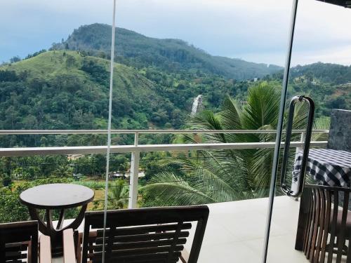 a balcony with a table and a view of a mountain at Ella HIDE VIEW in Ella