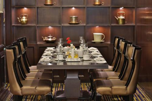 a dining room with a long table and chairs at Shakun Hotels And Resorts in Jaipur