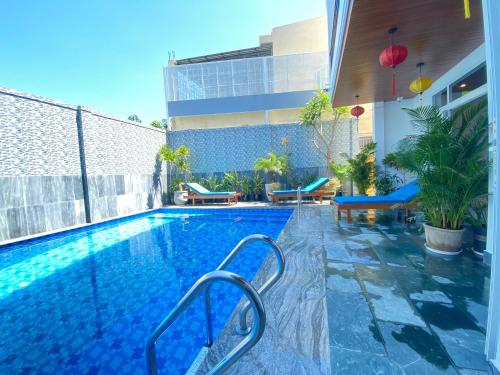 a swimming pool in a building with a building at White House Central Villa in Hoi An