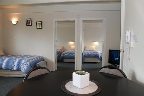 A bed or beds in a room at 252 Beachside Motels & Holiday Park