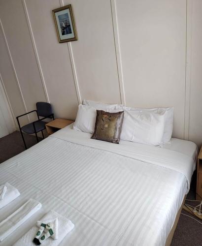 a bed with white sheets and pillows in a room at Lachlan Hotel 