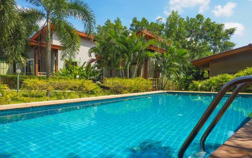 a swimming pool in front of a house at Escape-Cabins in Ko Lanta