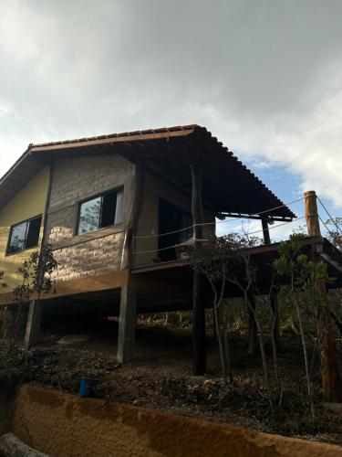 a house that is sitting on top of a hill at Chalé Pousada Maná do Céu - São Jorge in Sao Jorge