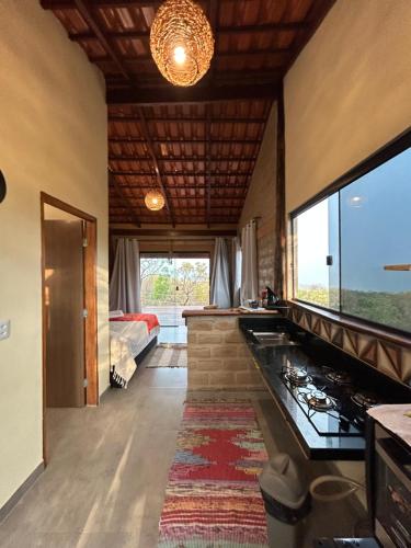 a living room with a kitchen and a bedroom at Chalé Pousada Maná do Céu - São Jorge in Sao Jorge