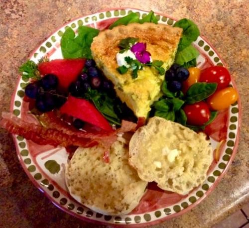 a plate of food with a slice of pizza and vegetables at Trail Boss King EnSuite-Prairie Rose B&B - 1200 sq ft Suite in Cheyenne
