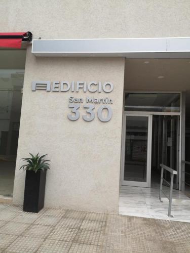 a sign on the side of a building at Departamento Temporario San Pedro in San Pedro