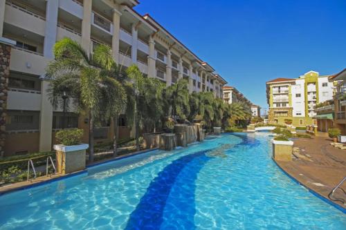 a large swimming pool in the middle of a building at Sorrento Oasis 2 BR in Manila