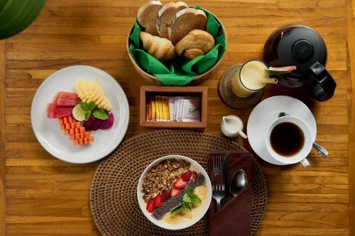 a table with plates of food and a cup of coffee at Arapan Ubud Eco Villa in Ubud