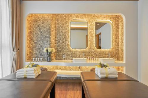 La salle de bains est pourvue de 2 lits et d'un grand miroir. dans l'établissement Convinia Luxury Starhill, à Hô-Chi-Minh-Ville