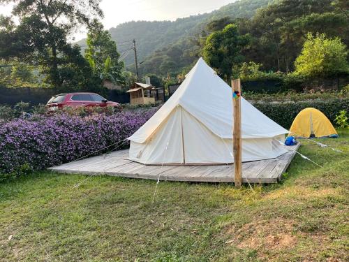 a white tent sitting in a field of grass at Lagom Village (Glamping Site) in Hanoi