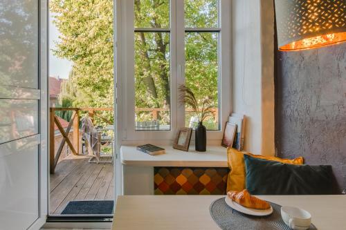 a living room with a bench and a window at 20 stairs in Vilnius