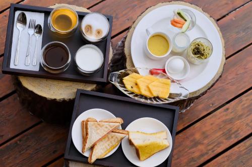 a table with two plates of food with toast and coffee at Love's World B&B in Jian