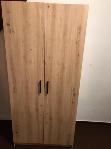 a wooden cabinet sitting next to a wall at Penzión Zátoka in Liptovský Mikuláš