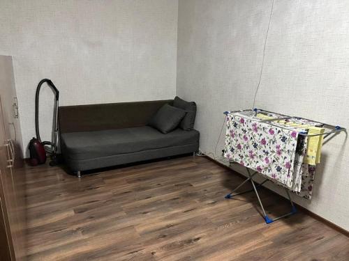 a small room with a couch and a table at Квартира in Karagandy
