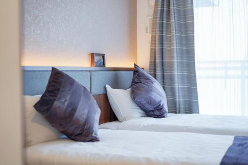two pillows on a bed in a hotel room at Apartment Hotel 11 Namba-Minami Ebisucho-Eki Mae in Osaka