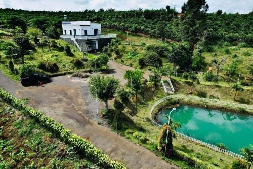 an aerial view of a house on a hill with a pool at Homestay Nhà Của Gạo in Bao Loc