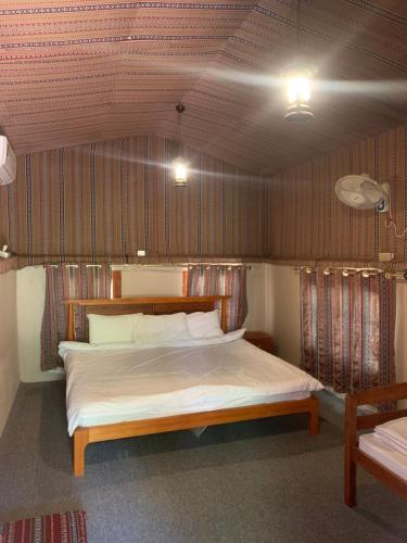 a bedroom with a large bed in a room at bait bimah travel lodge in Bīmah