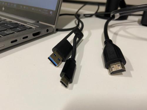 a laptop computer with a usb cable next to a laptop at Hamilton Hospital Retreat - 2 Bedroom Townhouse Modern Warm Quiet in Hamilton