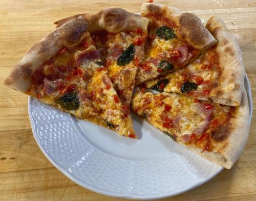 three slices of pizza on a white plate at Hotel U Beránků in Libochovice